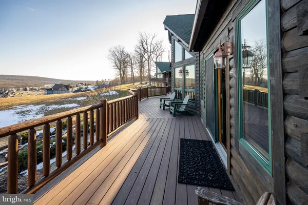 a bedroom with a bed a flat screen tv and chandelier
