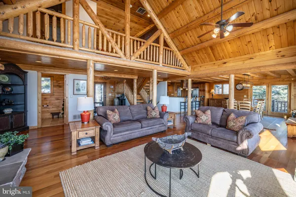 a living room with furniture a wooden floor and a large window