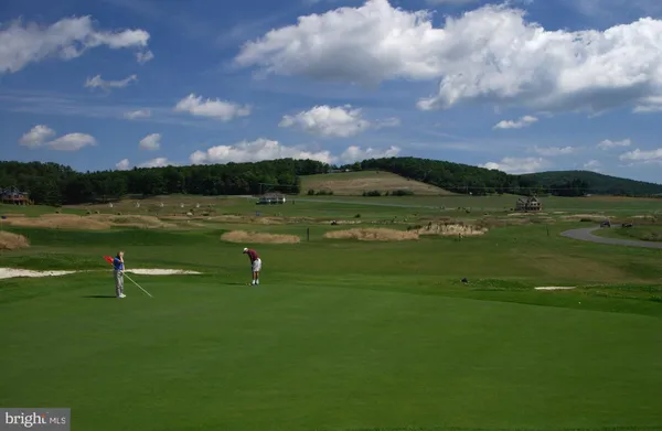 a view of a lake with houses in the back