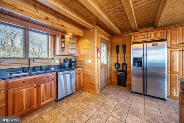 a kitchen with stainless steel appliances granite countertop a stove and cabinets