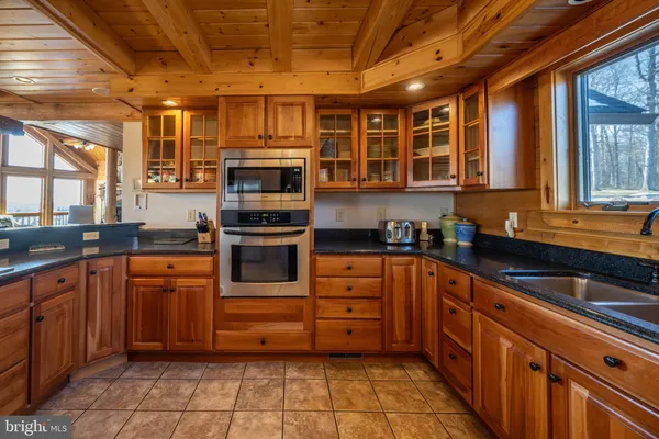 a kitchen with granite countertop a sink and cabinets
