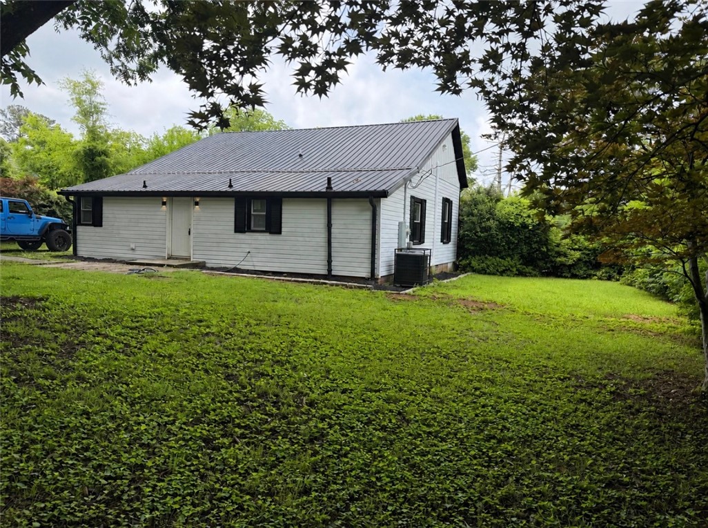 112 Simmons Street Anderson, SC 29625 - Photo 2 of 26 A well-maintained lawn surrounds this charming home with a durable metal roof.
