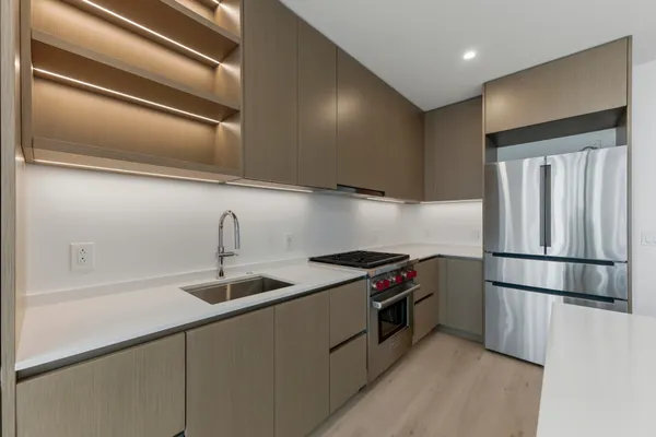 a view of a room with wooden floor and windows