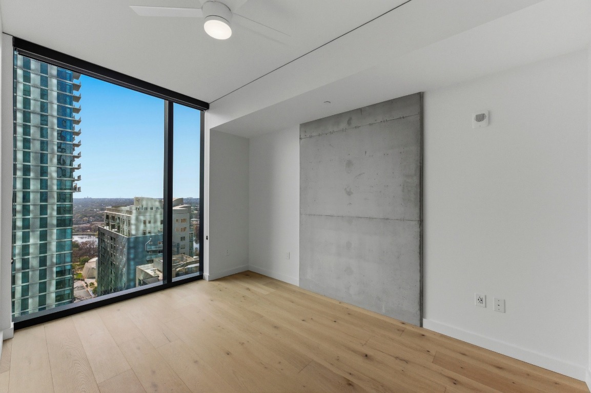 610 Davis Street, Unit 2204 Austin, TX 78701 - Photo 12 of 22 a view of a room with wooden floor and windows