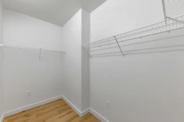a view of a room with wooden floor and windows