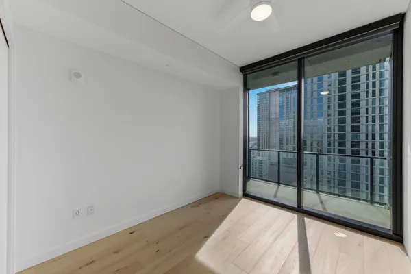 a view of an empty room with glass door