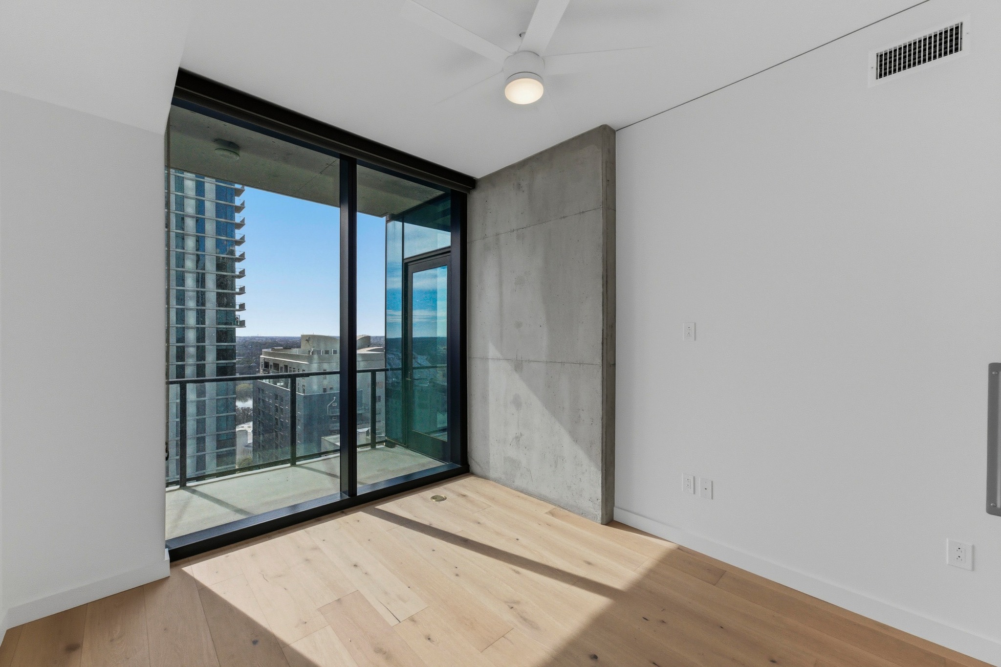 610 Davis Street, Unit 2204 Austin, TX 78701 - Photo 17 of 22 a view of an empty room with glass door