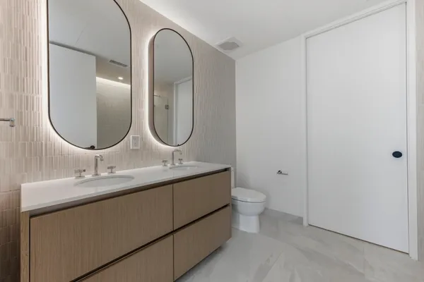 a bathroom with a double vanity sink and a mirror