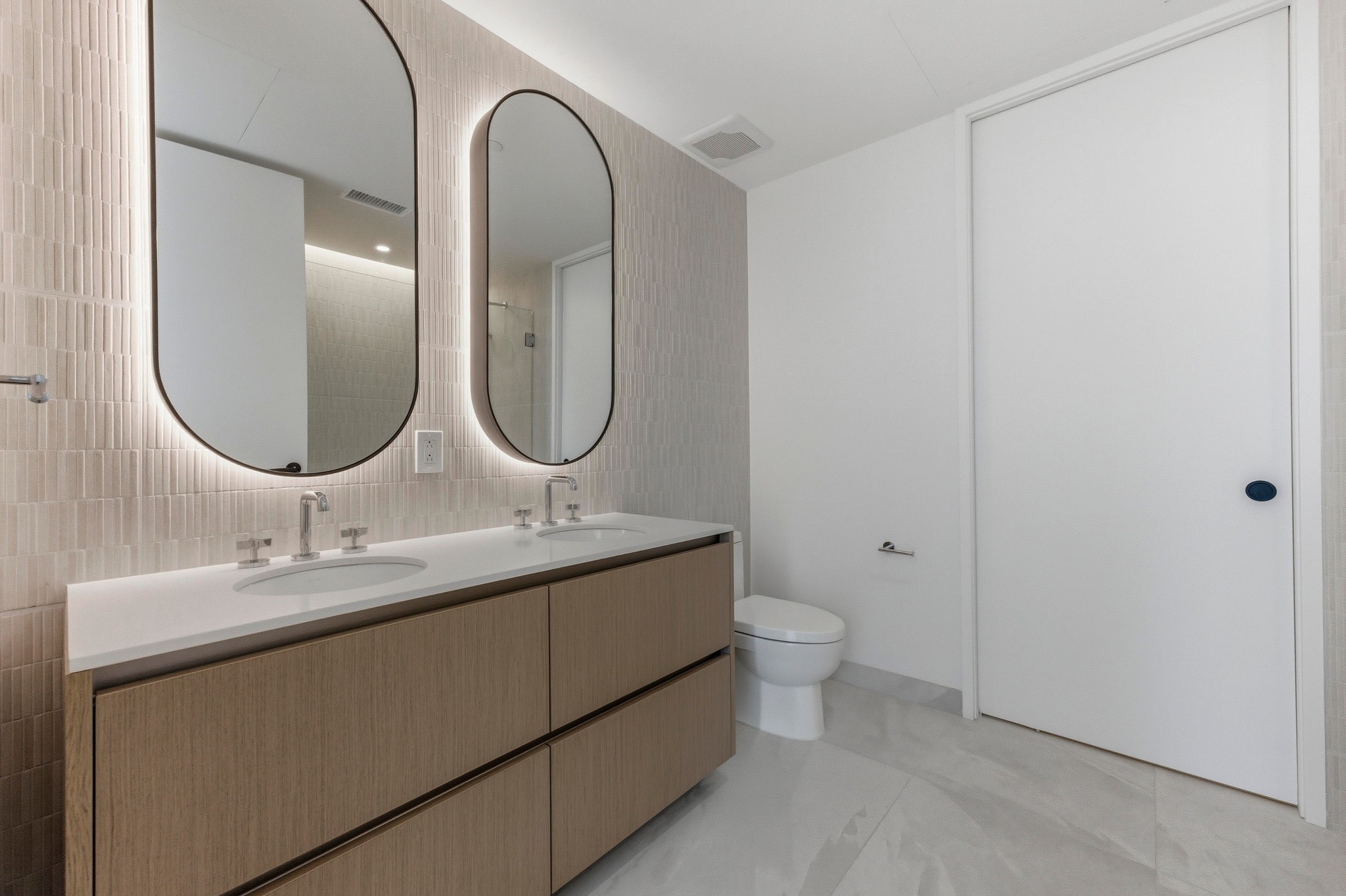 610 Davis Street, Unit 2204 Austin, TX 78701 - Photo 2 of 22 a bathroom with a double vanity sink and a mirror