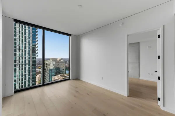 a view of a hallway with wooden shelves