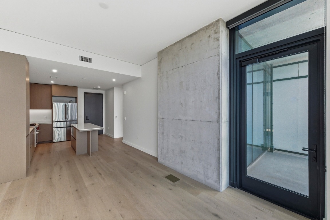 610 Davis Street, Unit 2204 Austin, TX 78701 - Photo 6 of 22 a view of a hallway with wooden shelves