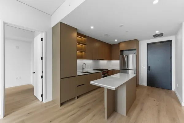 a kitchen with refrigerator cabinets and stainless steel appliances