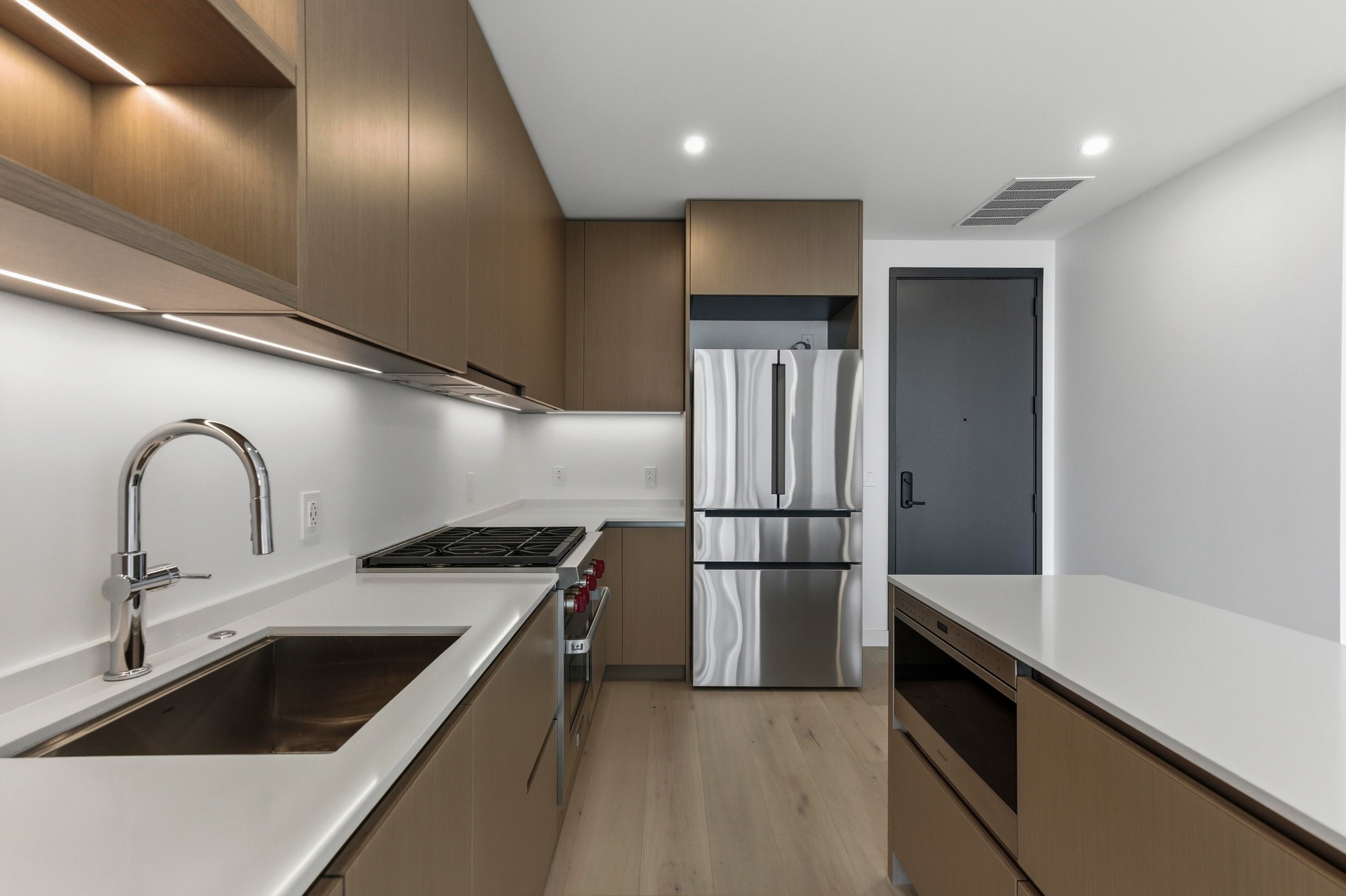 610 Davis Street, Unit 2204 Austin, TX 78701 - Photo 8 of 22 a kitchen with refrigerator cabinets and stainless steel appliances