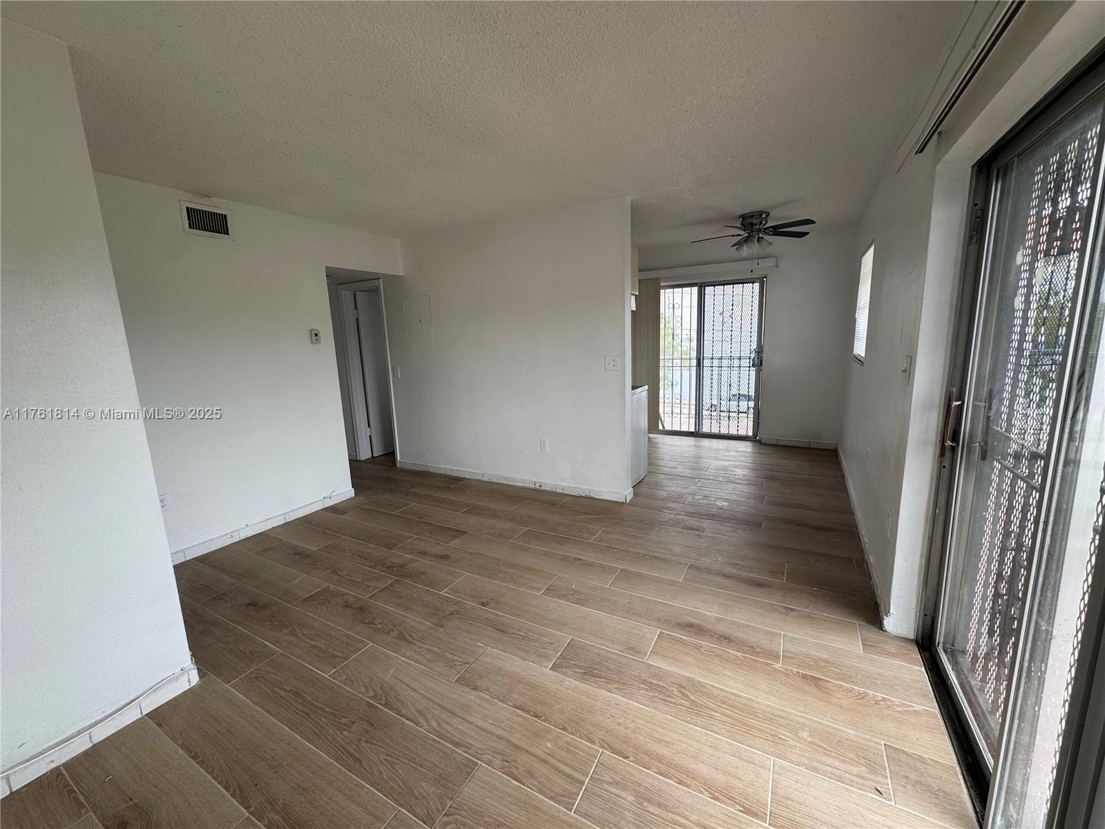 1126 Southwest 3rd Street, Unit 3 Miami, FL 33130 - Photo 3 of 9 a view of a hallway view with wooden floor and staircase