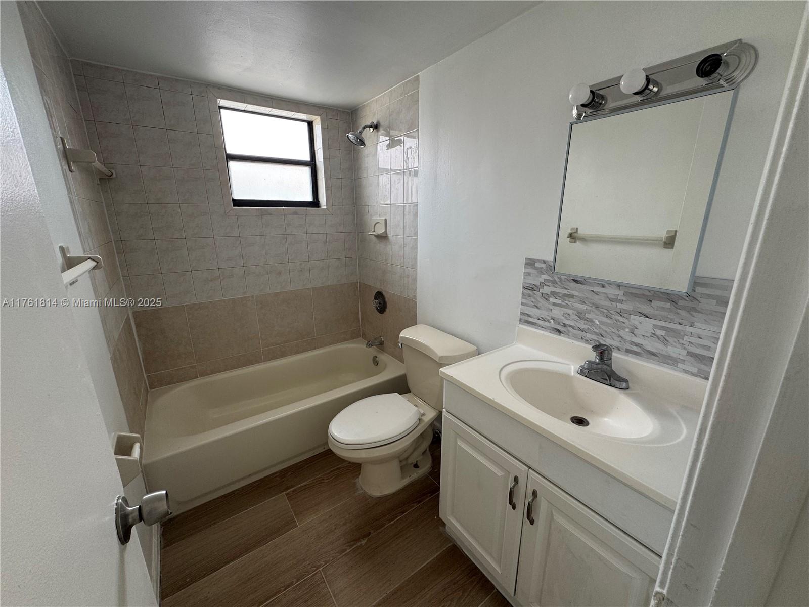 1126 Southwest 3rd Street, Unit 3 Miami, FL 33130 - Photo 4 of 9 a bathroom with a sink a toilet and bathtub