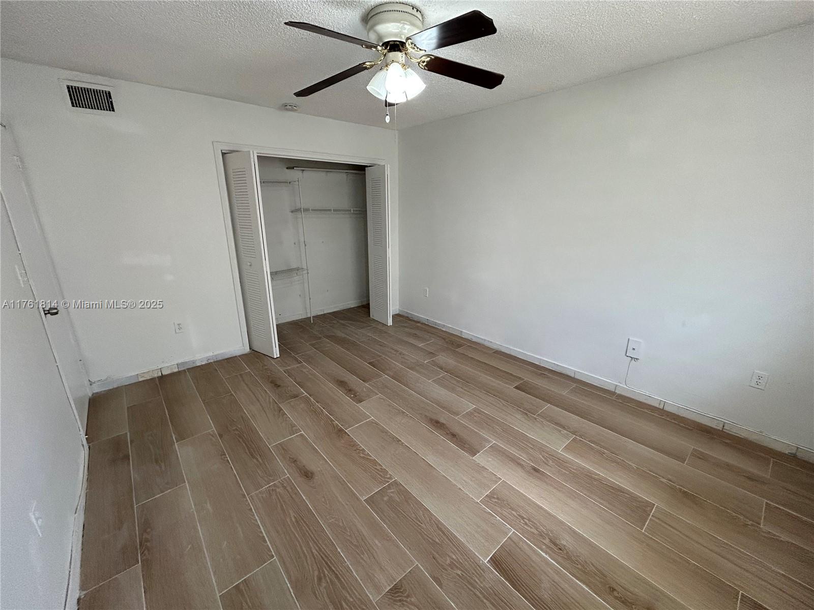 1126 Southwest 3rd Street, Unit 3 Miami, FL 33130 - Photo 7 of 9 a view of empty room with wooden floor