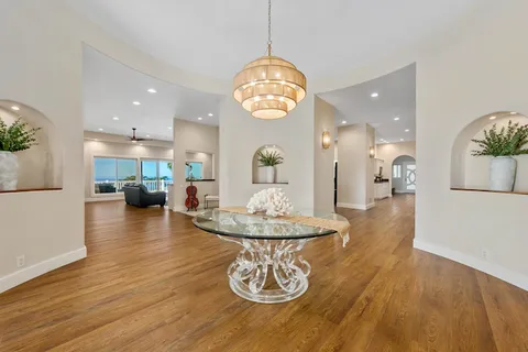 a view of a dining room with furniture wooden floor and a chandelier