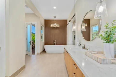 a spacious bathroom with a double vanity sink and a mirror