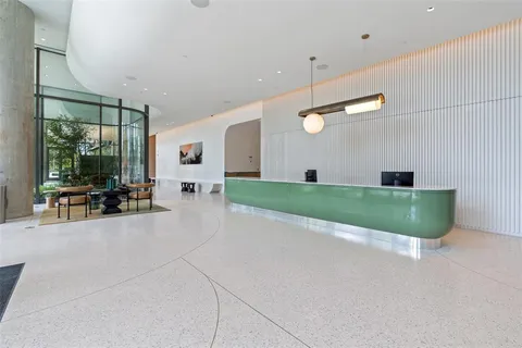 a view of a livingroom with furniture and floor to ceiling window