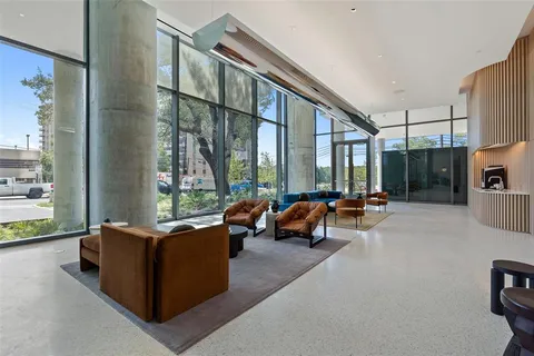 a living room with furniture and a floor to ceiling window