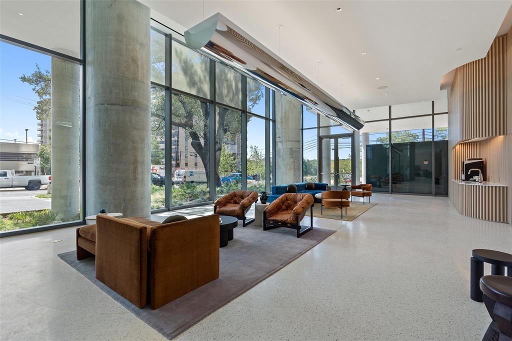 44 East Avenue, Unit 4402 Austin, TX 78701 - Photo 14 of 39 a living room with furniture and a floor to ceiling window