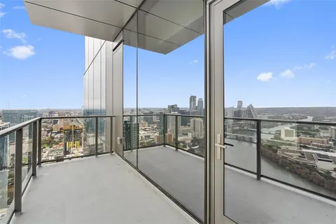 a large white kitchen with a large window