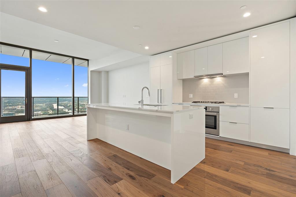 44 East Avenue, Unit 4402 Austin, TX 78701 - Photo 26 of 39 a large white kitchen with a large window