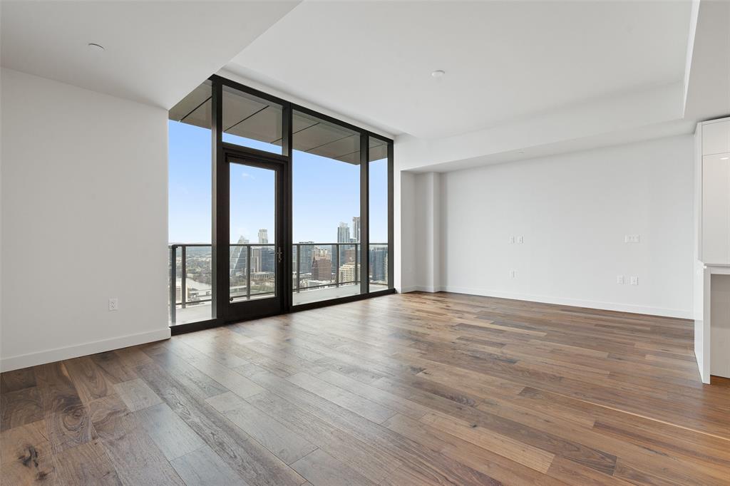 44 East Avenue, Unit 4402 Austin, TX 78701 - Photo 28 of 39 a view of an empty room with wooden floor and a window