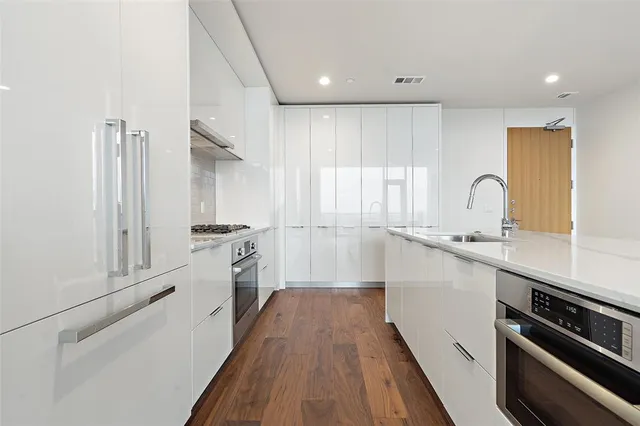 a stove top oven sitting inside of a kitchen