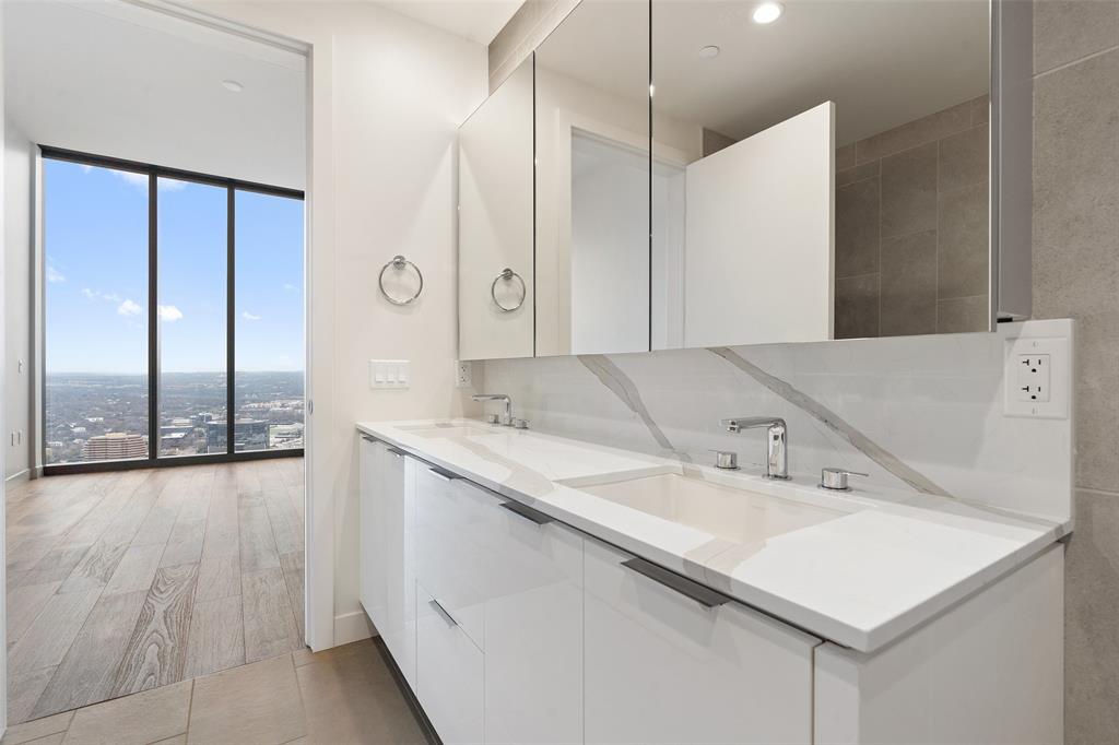 44 East Avenue, Unit 4402 Austin, TX 78701 - Photo 37 of 39 a bathroom with a sink and a mirror