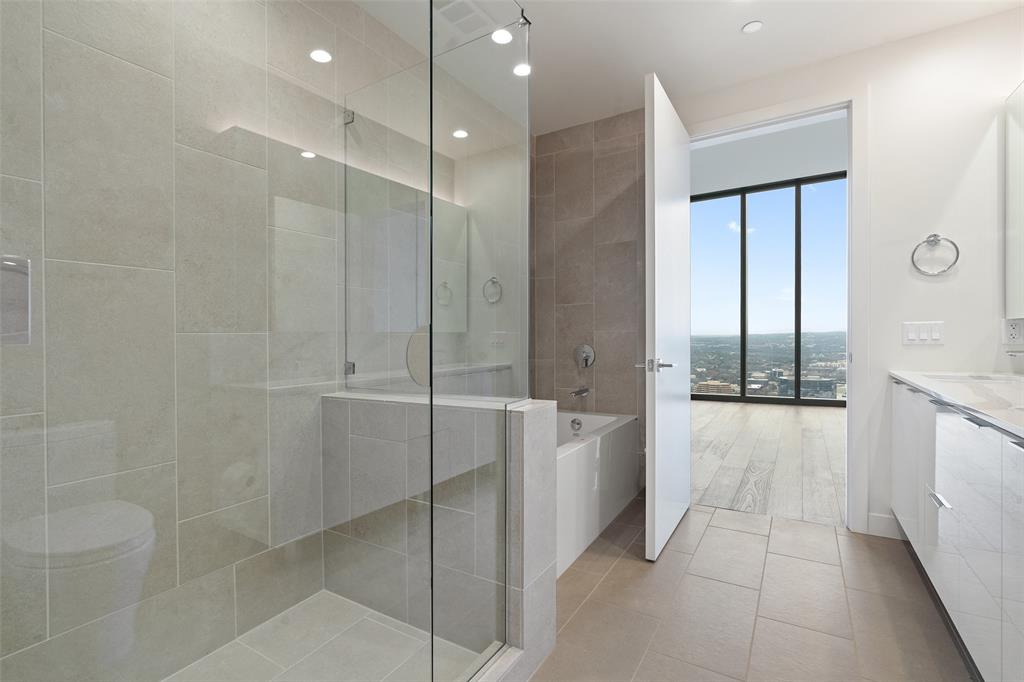 44 East Avenue, Unit 4402 Austin, TX 78701 - Photo 38 of 39 a bathroom with a bathtub and a shower