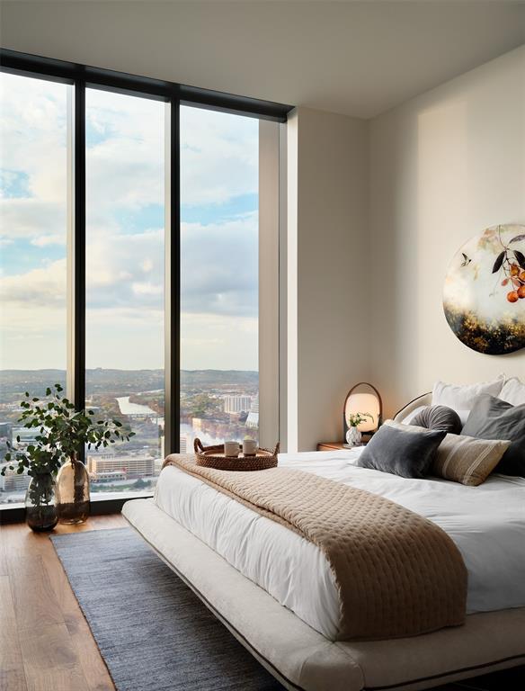 44 East Avenue, Unit 4402 Austin, TX 78701 - Photo 4 of 39 a bedroom with a bed and large windows