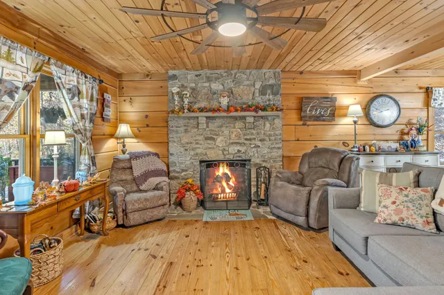 a living room with furniture a flat screen tv and a fireplace
