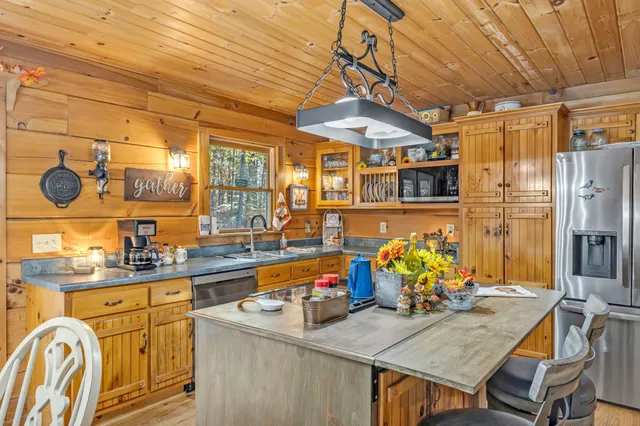 a kitchen with granite countertop lots of counter top space and wooden floor