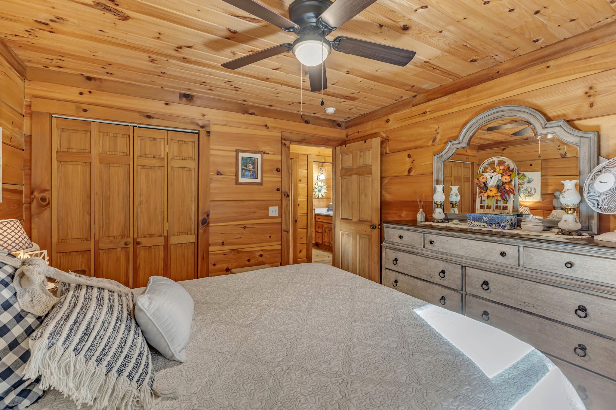 5833 Dewey Carr Road Bethpage, TN 37022 - Photo 28 of 60 a bedroom with a large bed and a chandelier