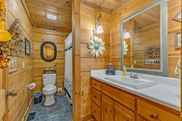 a living room with furniture and a ceiling fan