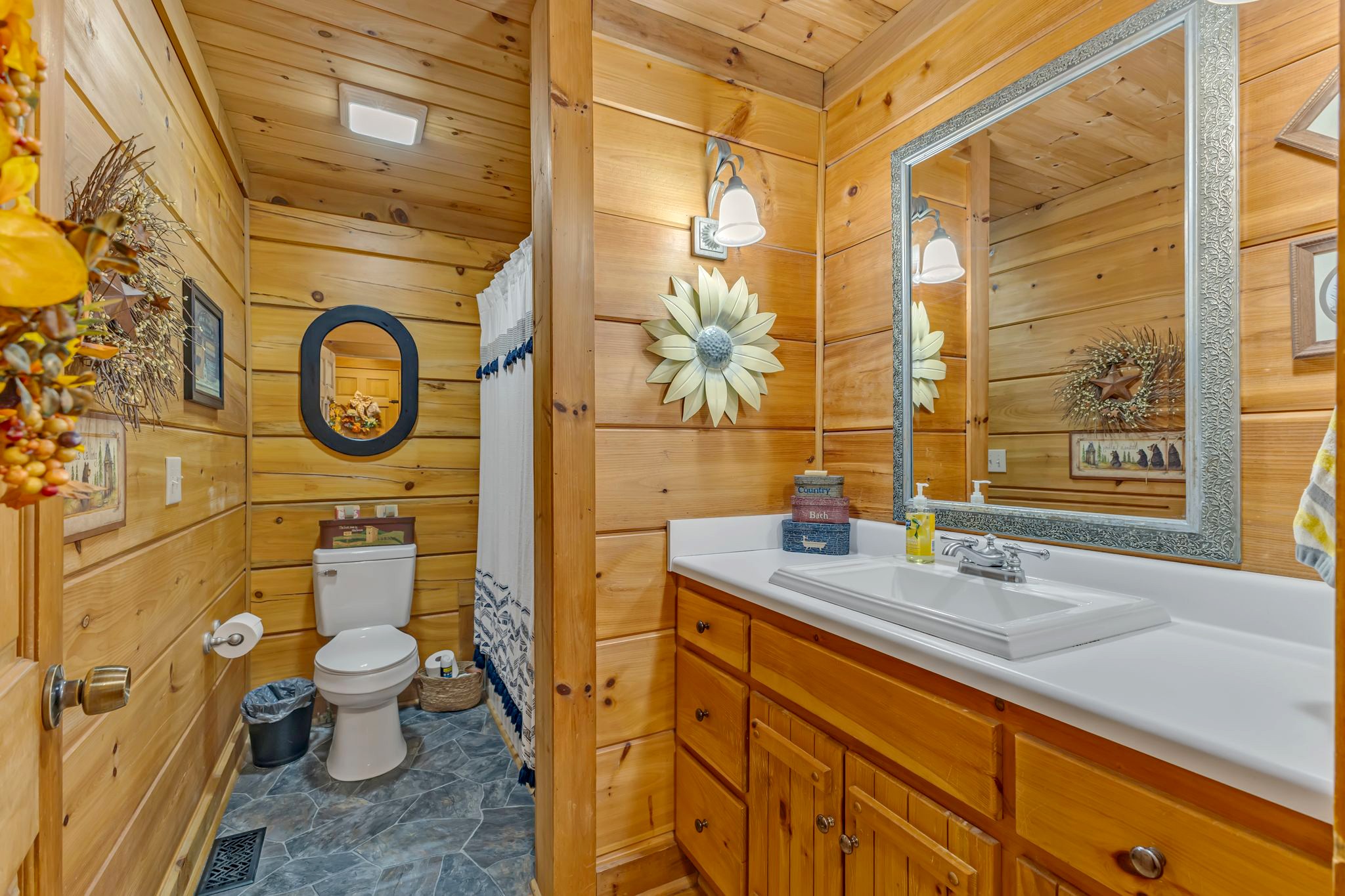 5833 Dewey Carr Road Bethpage, TN 37022 - Photo 29 of 60 a bathroom with a granite countertop toilet sink and a mirror