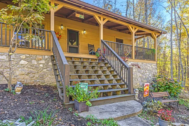 a view of front door of house with wooden stairs