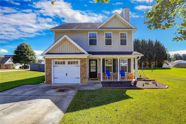 a front view of a house with a yard and garage