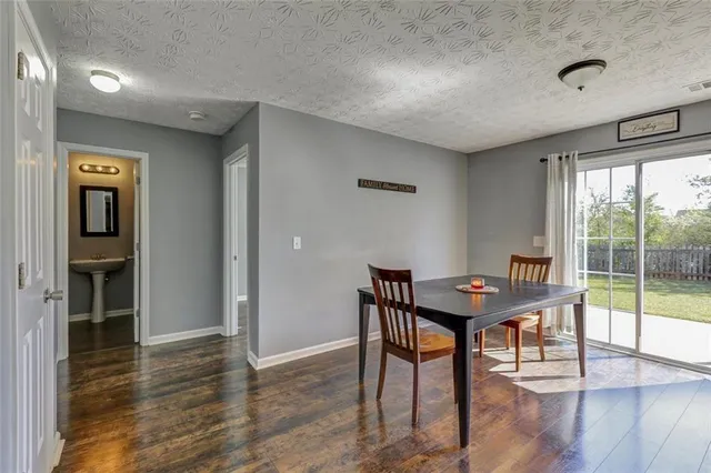 a view of a workspace with furniture and window
