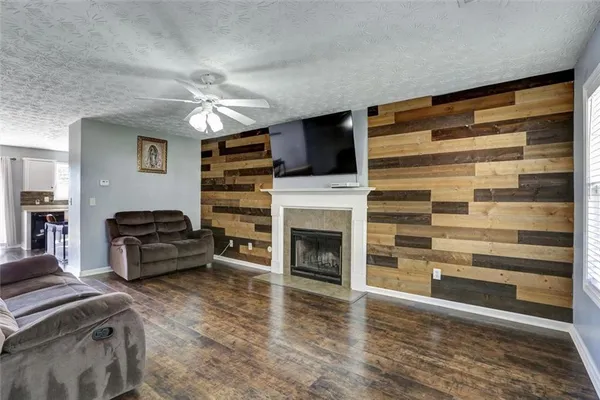 a living room with furniture a fireplace and a flat screen tv