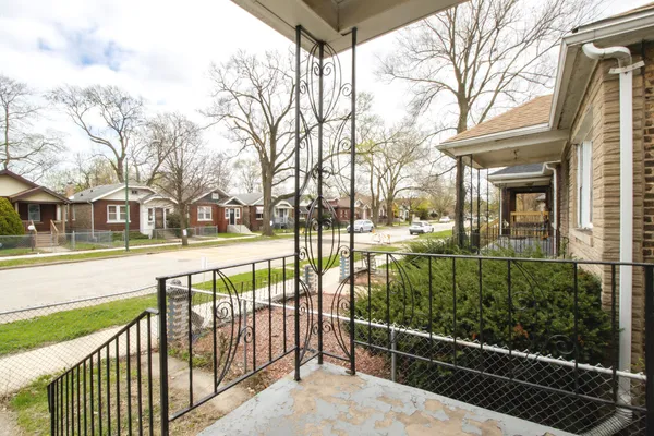 a view of a balcony with yard