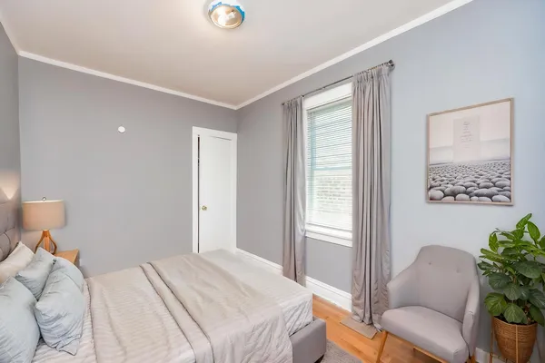 a bedroom with a bed and a chair