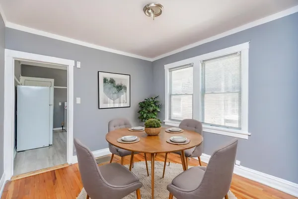 a dining room with furniture and window