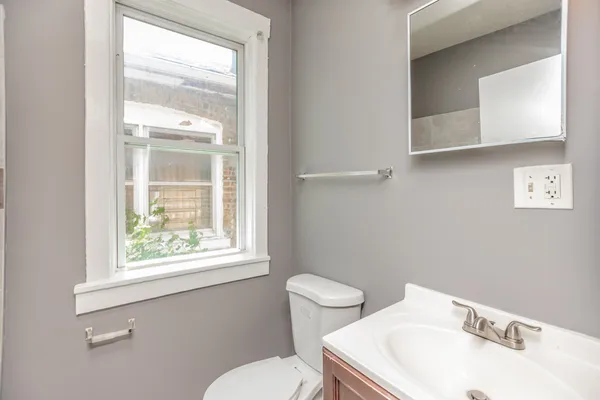 a white toilet sitting next to a bathroom sink