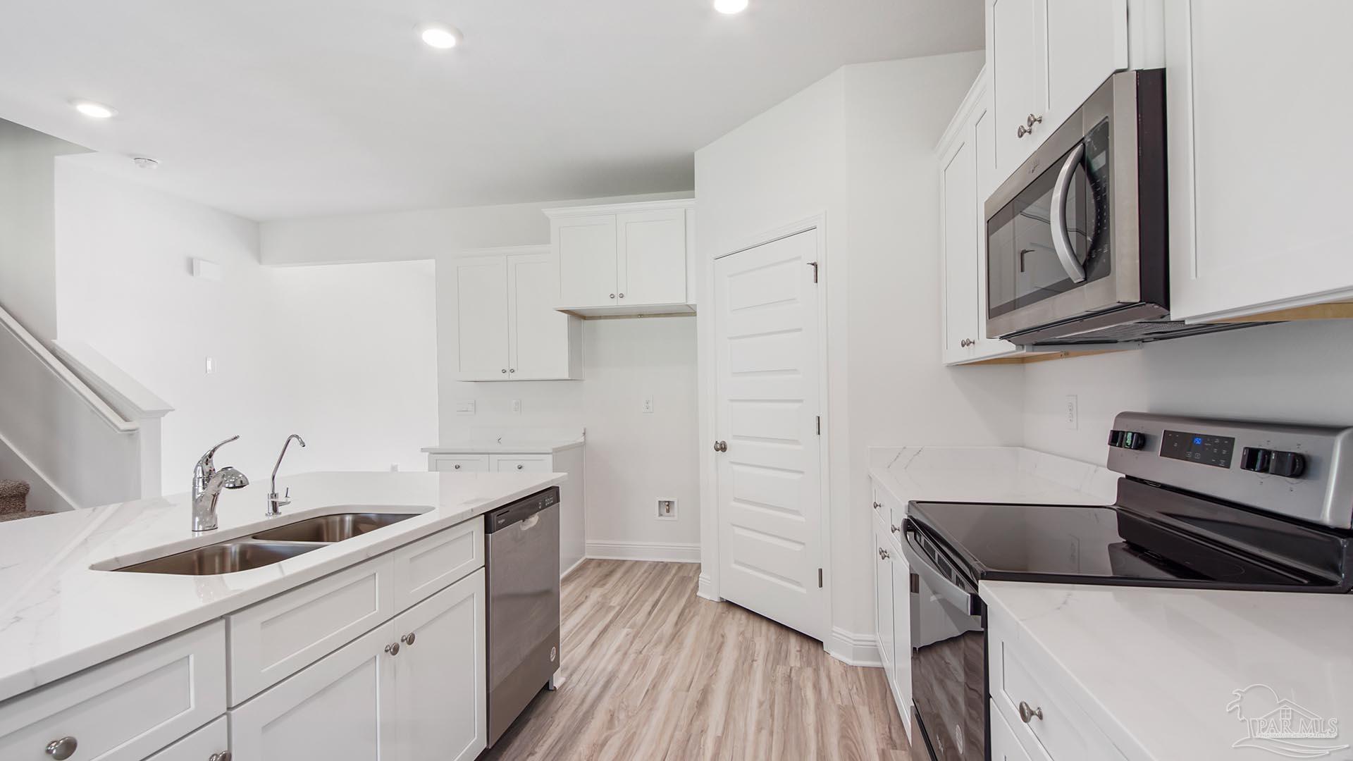 3233 Harrier Road Pace, FL 32571 - Photo 35 of 50 a kitchen with stainless steel appliances a sink and cabinets