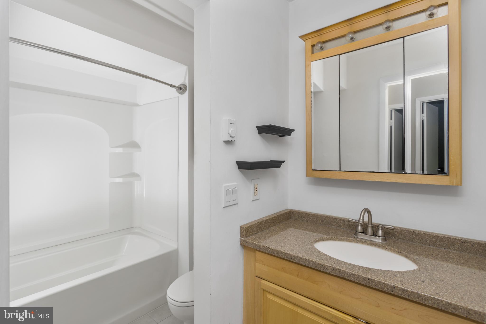 41 Overlook Drive Clinton, NJ 08809 - Photo 19 of 24 a bathroom with a granite countertop sink toilet and shower