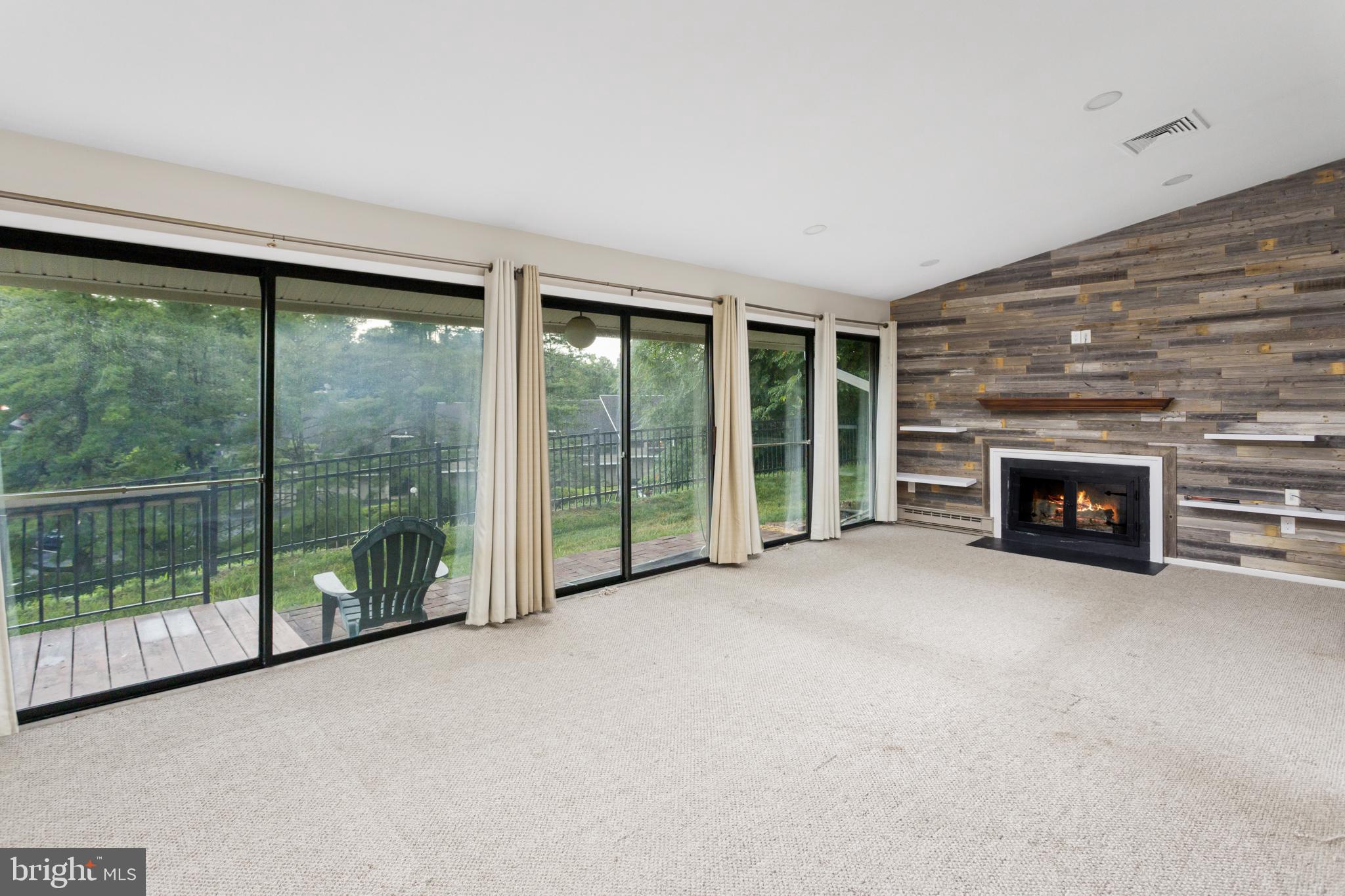 41 Overlook Drive Clinton, NJ 08809 - Photo 10 of 24 a view of an empty room with windows and a fireplace