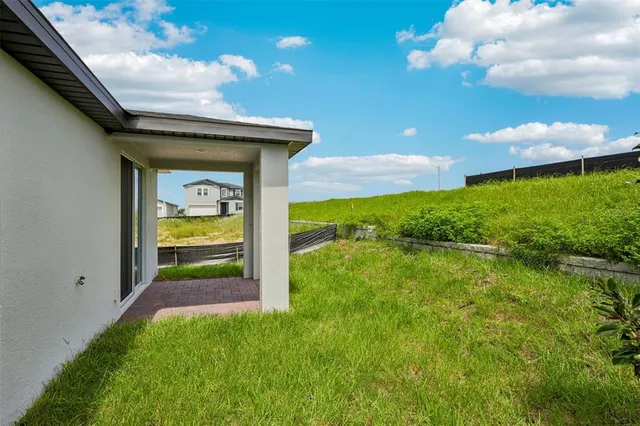 a backyard of a house with lots of green space