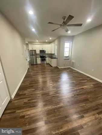 a view of a room with wooden floor